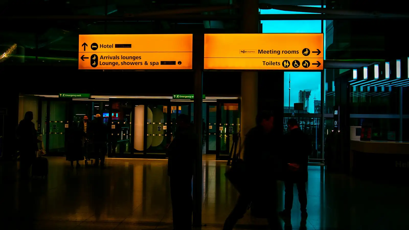 Airport arrivals signs pointing to the meeting point
